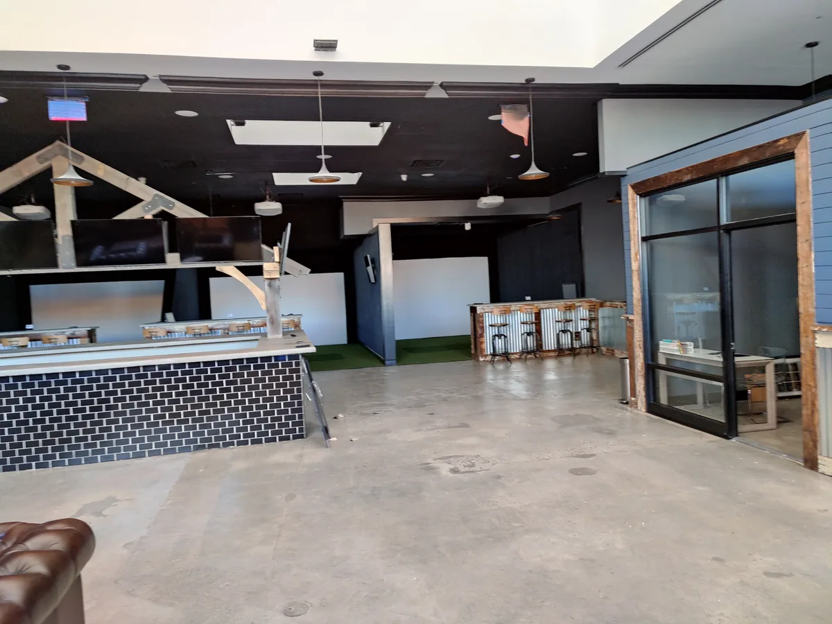 Full venue layout showing integrated AV displays, bar area, and commercial sound system
