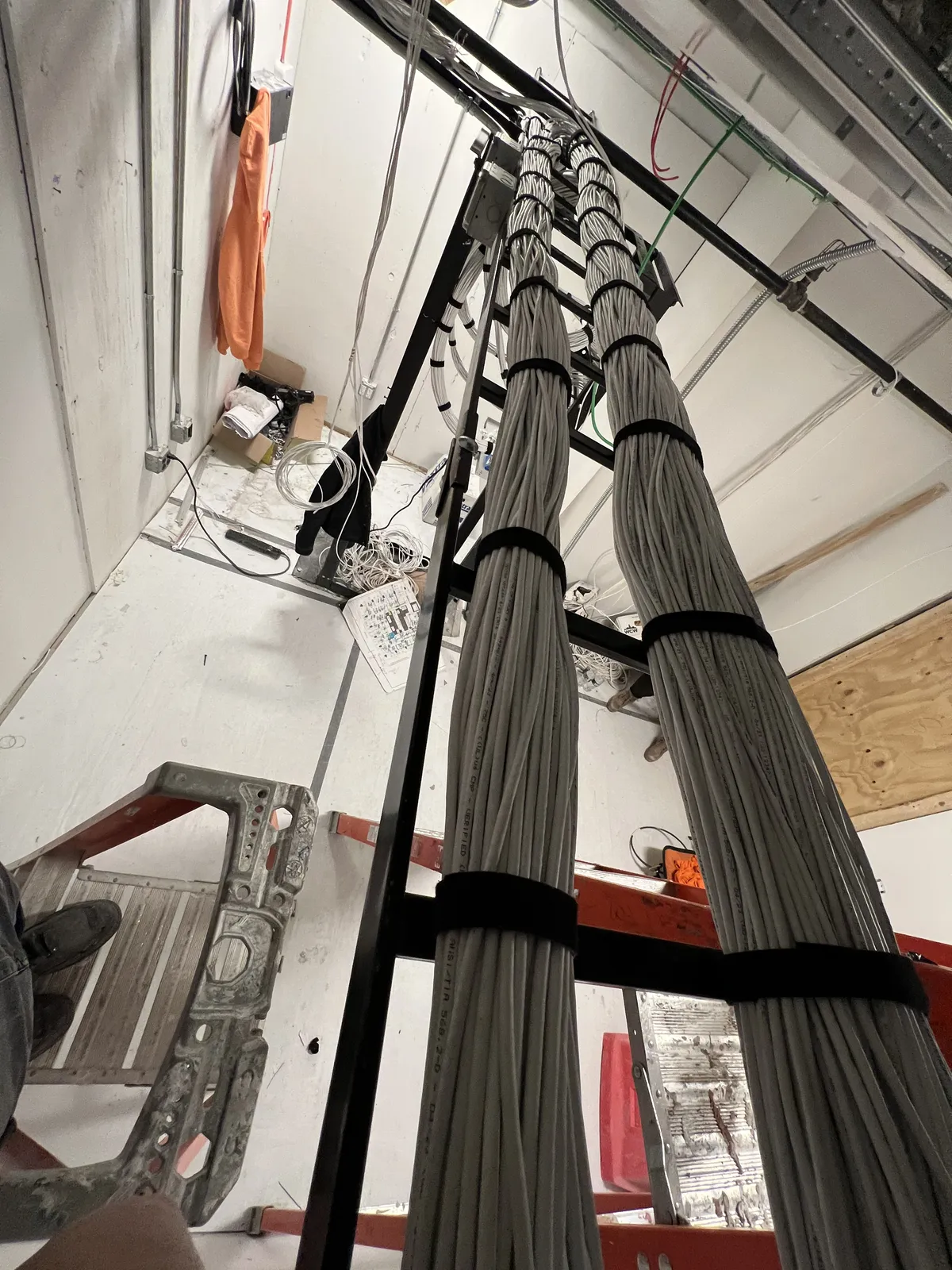 Vertical cable bundles on ladder rack — close-up of dressed Cat 6A runs with velcro ties
