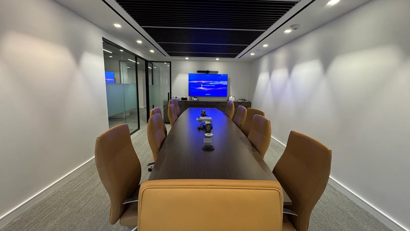 Zoom Room boardroom with a large display and integrated room camera
