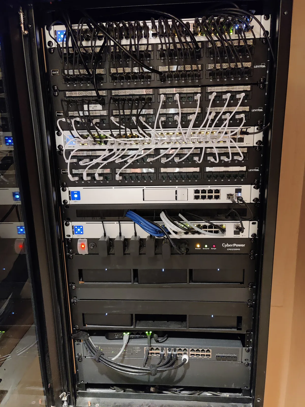 Network rack front view — Leviton patch panels, managed switches, and CyberPower UPS