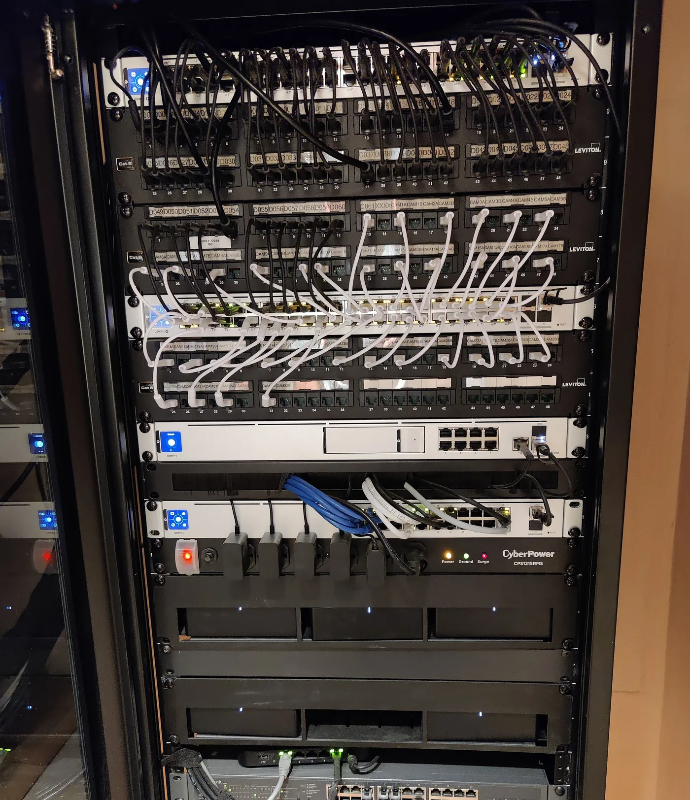 Network rack with managed switches, patch panels, and a CyberPower UPS