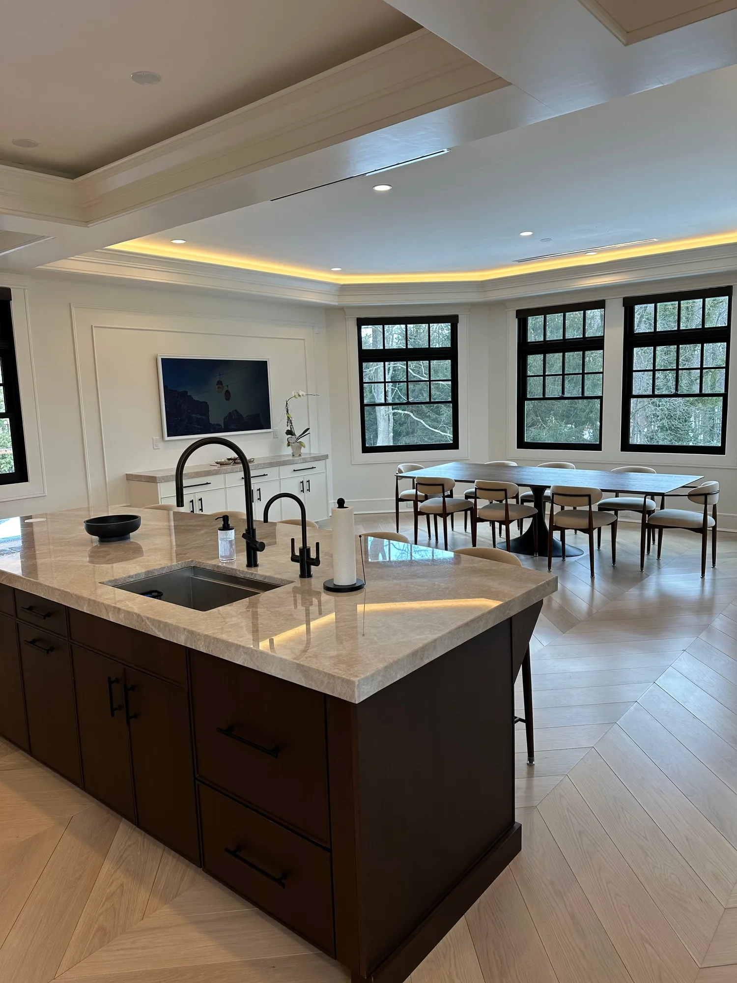 High-end NY/NJ whole-home renovation with an open kitchen, marble waterfall island, integrated wall display, and invisible in-wall audio