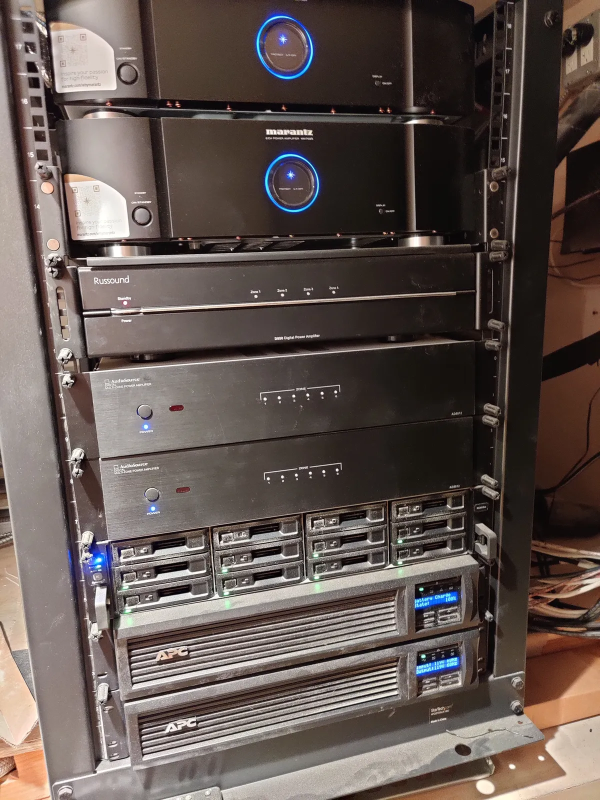 AV equipment rack with Marantz amplifiers, Russound multi-zone audio, and APC UPS